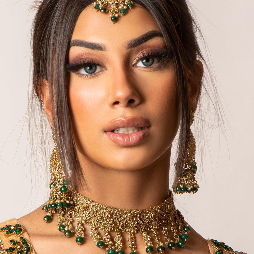 
                  
                    gold and green necklace 
                  
                